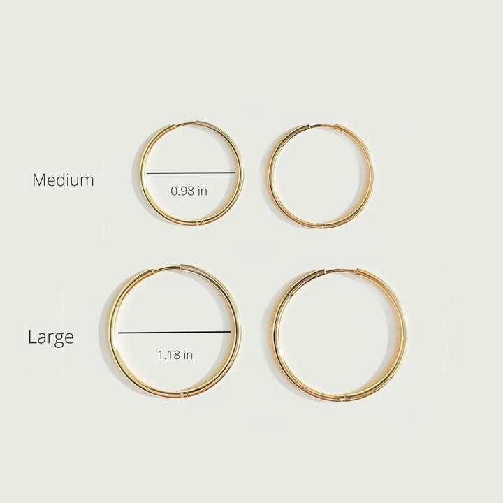 Versatile thin hoop earrings for women. Enhance your look with these delicate gold or silver everyday jewelry pieces.