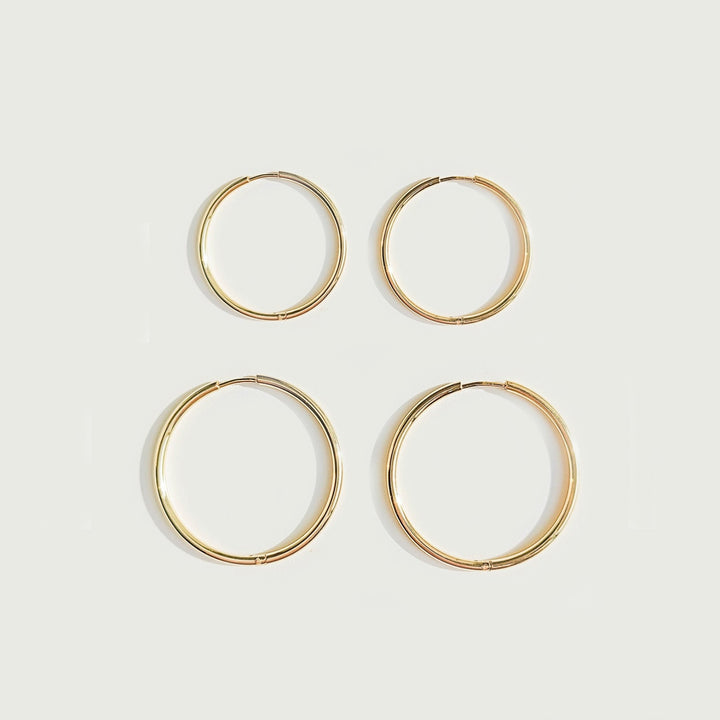 Hypoallergenic thin hoop earrings for women. Stylish and comfortable delicate gold or silver hoops.