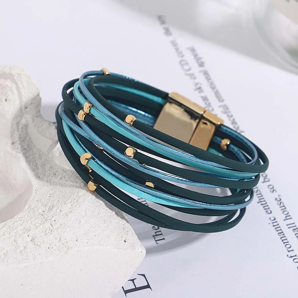 Close-up of a women's multi-layer tri-color wrap bracelet, highlighting the sleek magnetic clasp.
