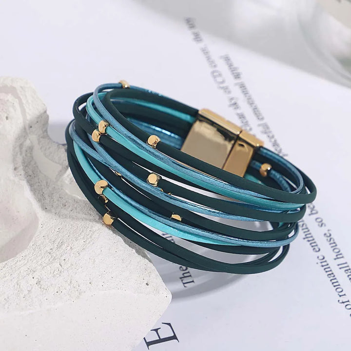 Close-up of a women's multi-layer tri-color wrap bracelet, highlighting the sleek magnetic clasp.