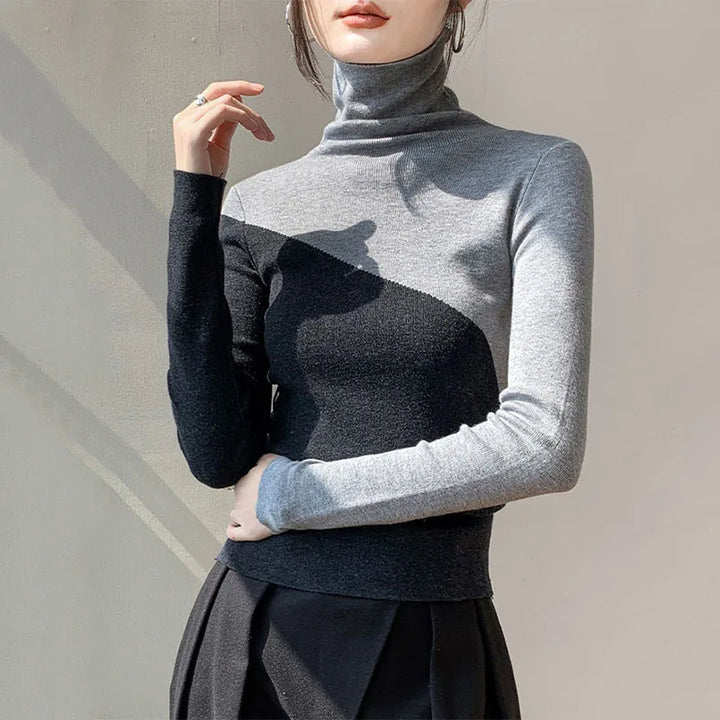Fashionable women's two-tone sweater with a distinct split color in khaki and gray hues, a modern top.