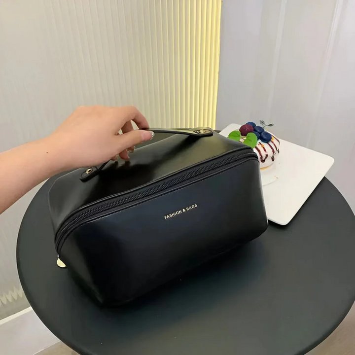 Sleek women's waterproof makeup organizer, closed view highlights its durable design for beauty travel.