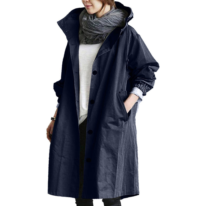 Woman wearing a chic long waterproof trench coat, ideal for outdoor wear and everyday rain protection.