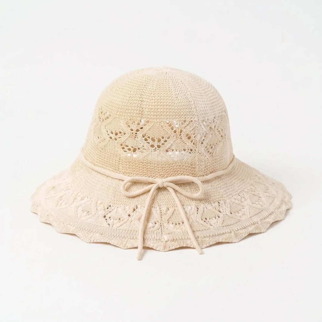 Elegant women's wide brim sun hat, ideal beach accessory & travel shade for a chic summer look.