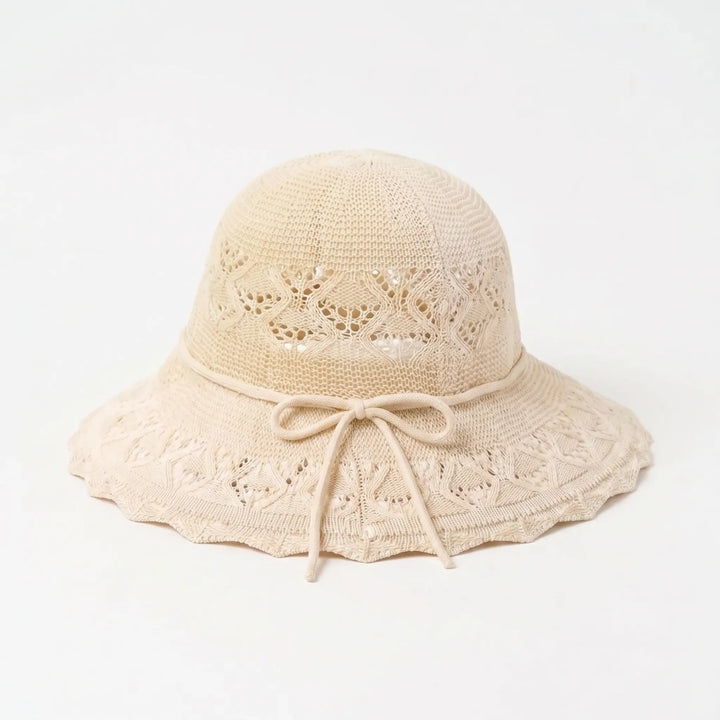 Elegant women's wide brim sun hat, ideal beach accessory & travel shade for a chic summer look.