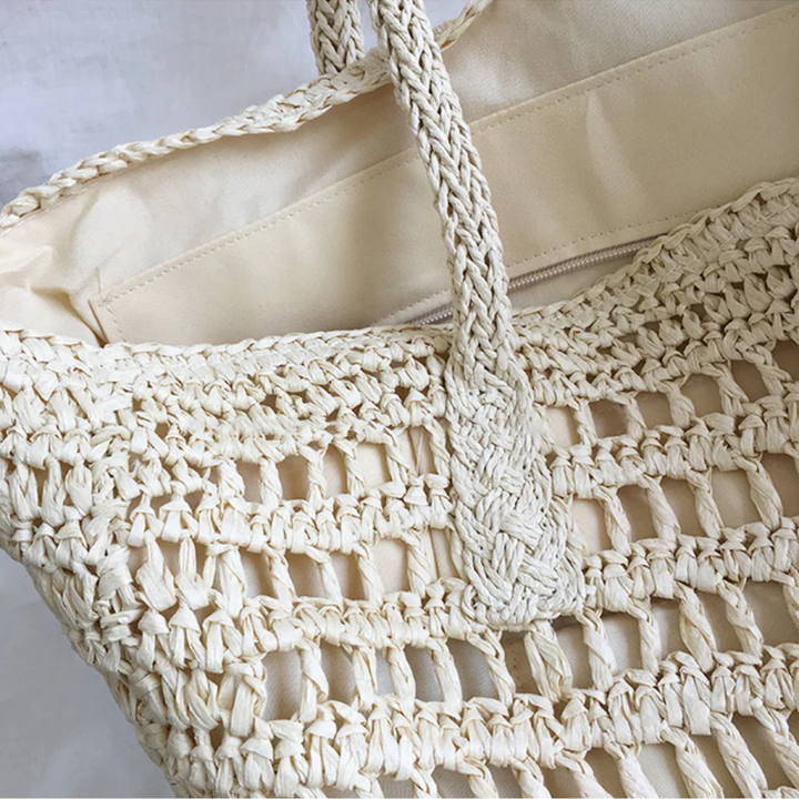 Women's stylish woven shoulder bag, a chic fashion accessory for beach trips or daily wear.