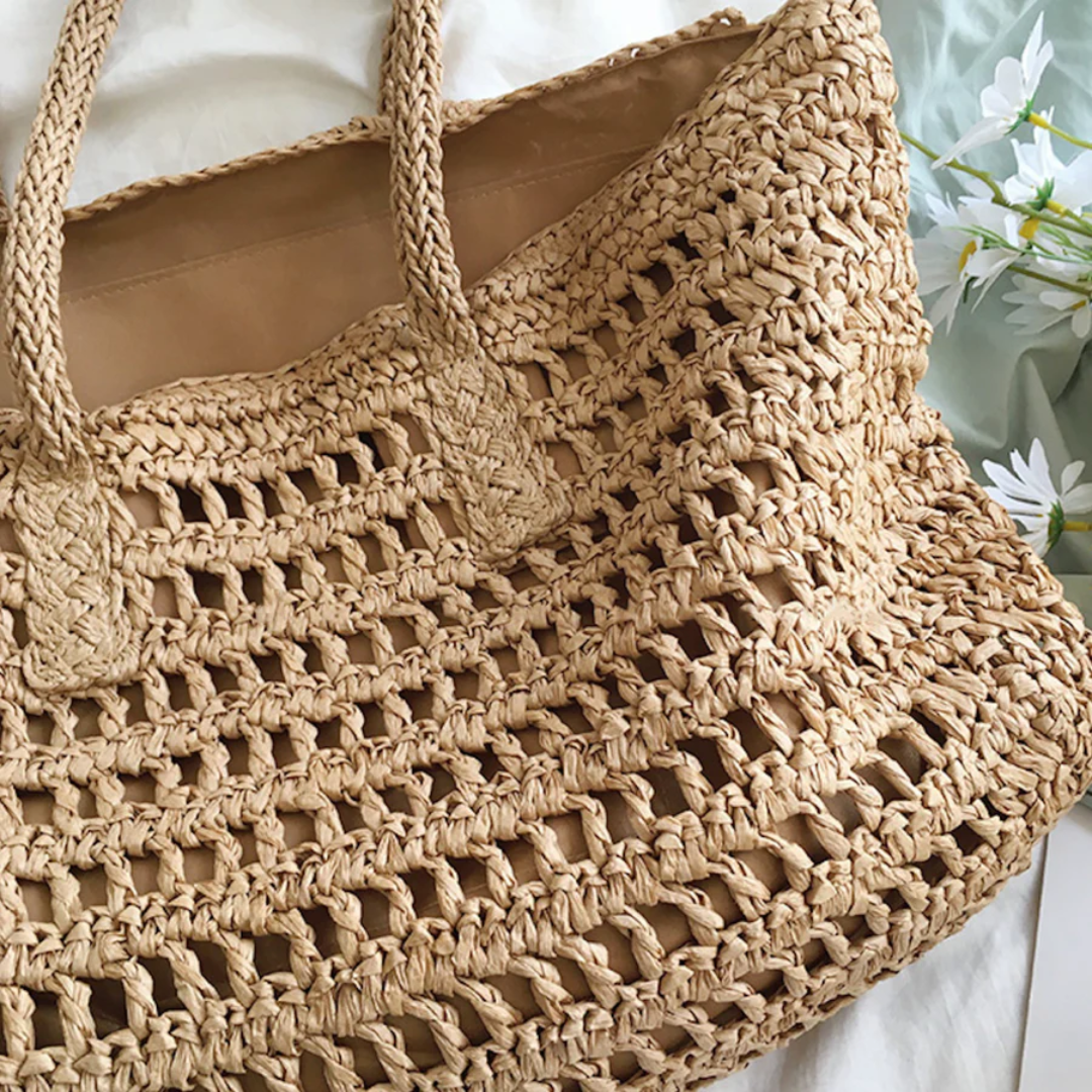 Women's spacious woven tote bag, perfect for carrying beach essentials or as a fashionable summer shoulder bag.