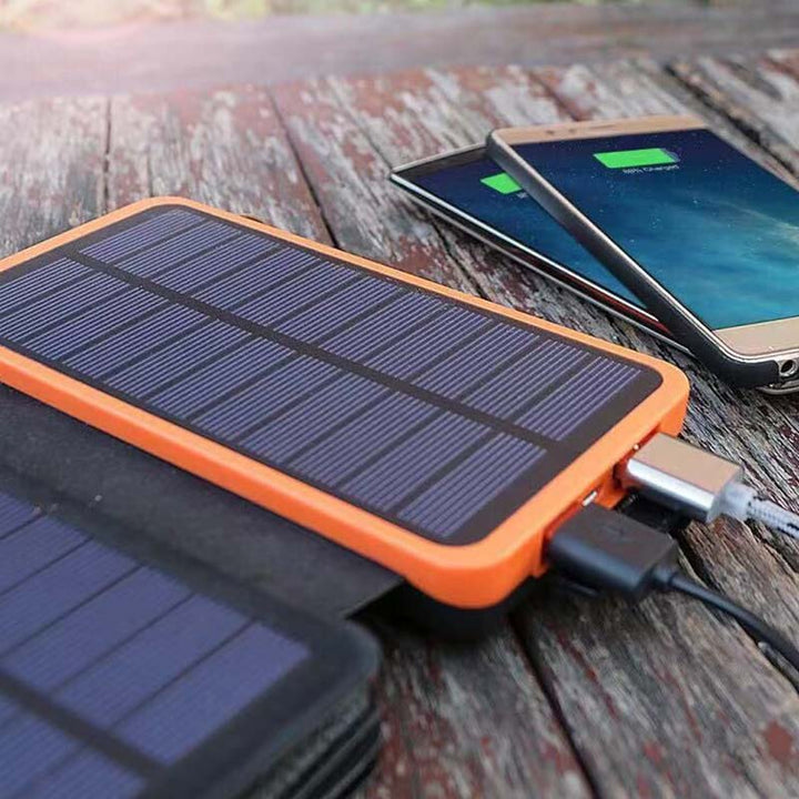 Unisex using SunCore 4-panel solar power bank to charge phone, practical portable charger for travel