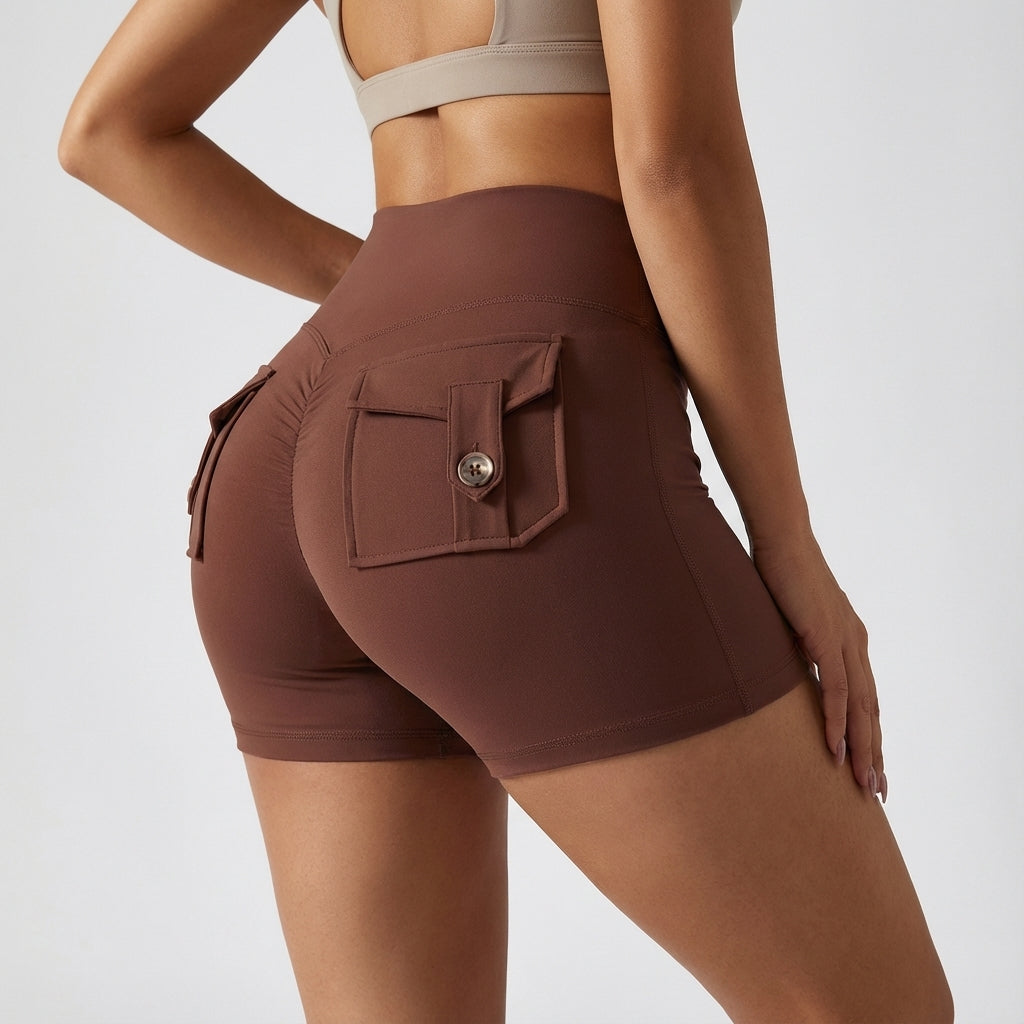 Model wearing women's high-waisted sports shorts with pockets, demonstrating activewear comfort and fit.