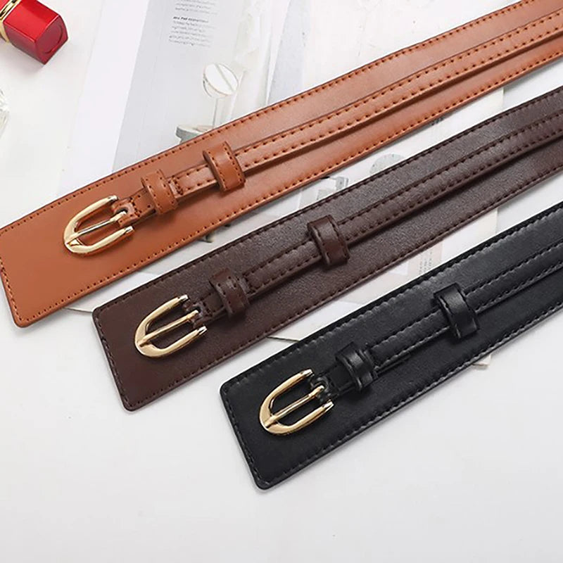 Classic black dual-strap vegan leather women's belt, an essential and adjustable fashion accessory.