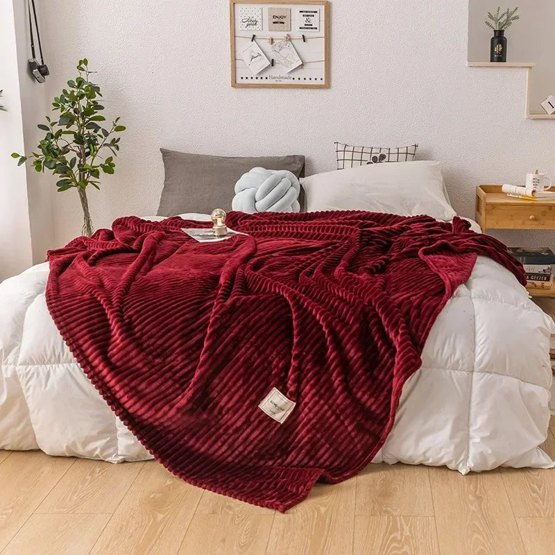 Close-up of a textured flannel throw blanket, showcasing its cozy and soft fabric.