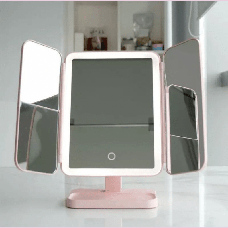 Tri-fold LED vanity mirror with adjustable lighting, perfect for detailed cosmetic application.