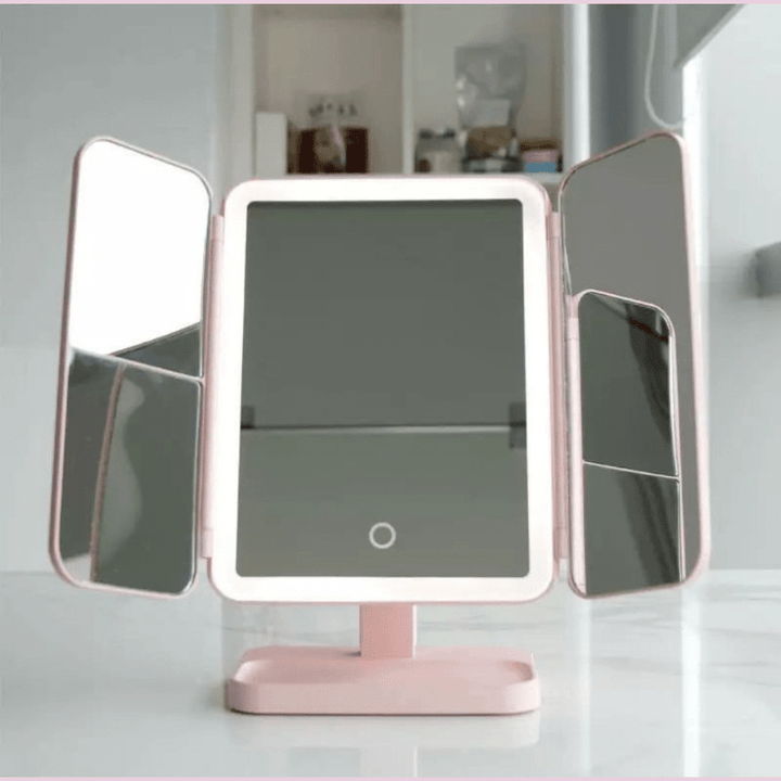 Tri-fold LED vanity mirror with adjustable lighting, perfect for detailed cosmetic application.