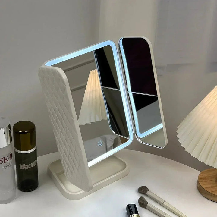 Tri-fold vanity mirror with integrated LED lights, enhancing home decor and beauty routines.