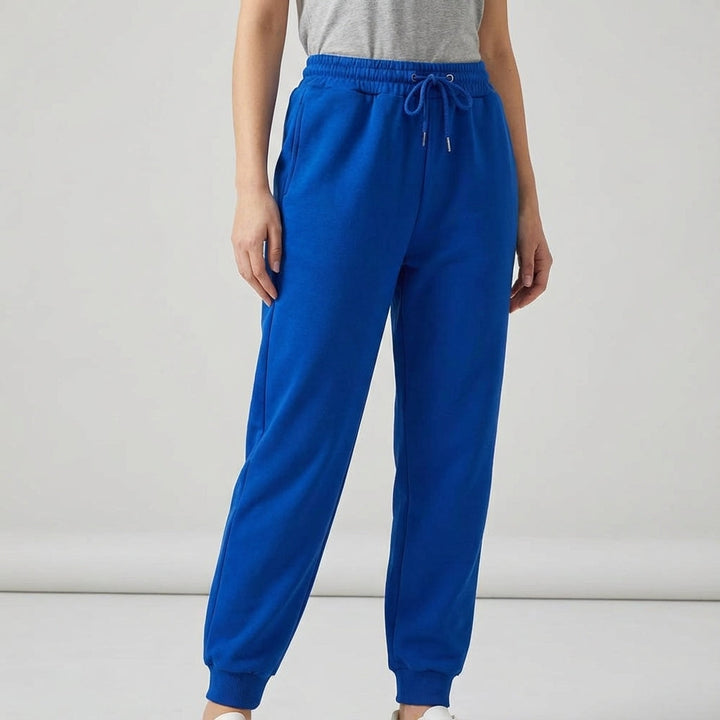 Model wearing Tiffany women's activewear joggers in a relaxed pose, showcasing comfort and style