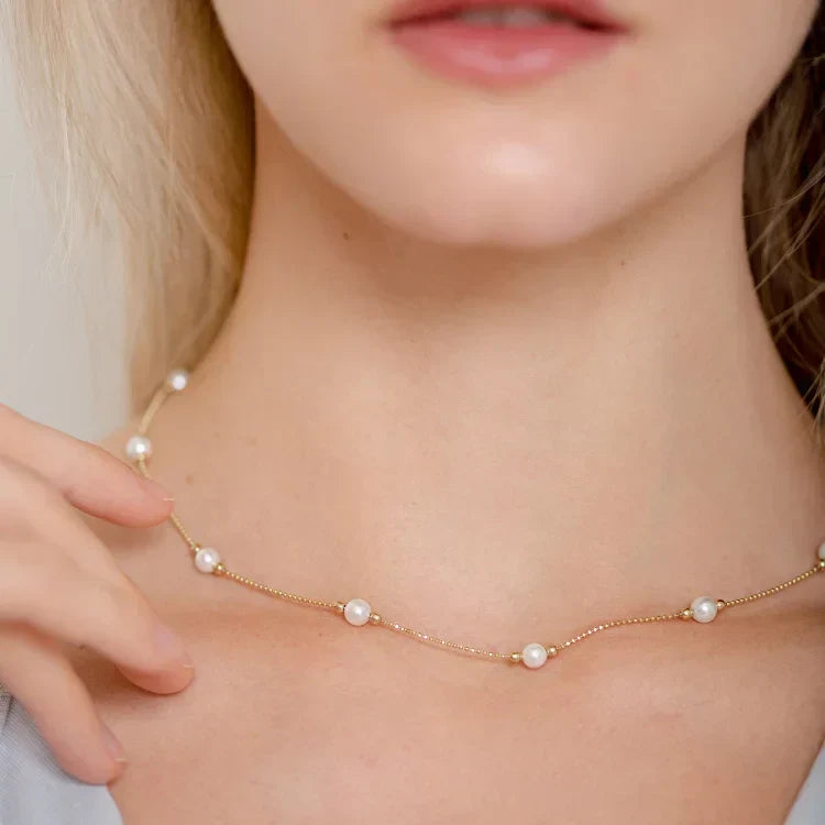Classic golden pearl necklace, a perfect timeless gift for her. Delicate women's fashion accessory.