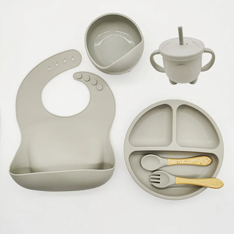 Easy-clean silicone baby feeding set for independent mealtimes, includes suction plate & fork.