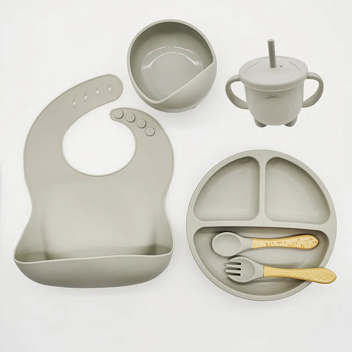 Easy-clean silicone baby feeding set for independent mealtimes, includes suction plate & fork.