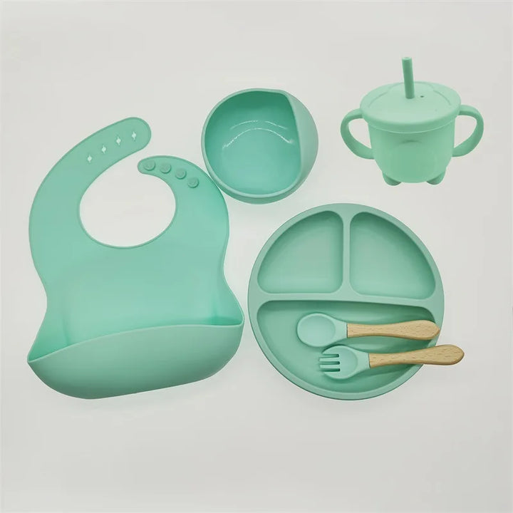 Non-slip silicone feeding set helps babies self-feed, with a strong suction plate & spoon.