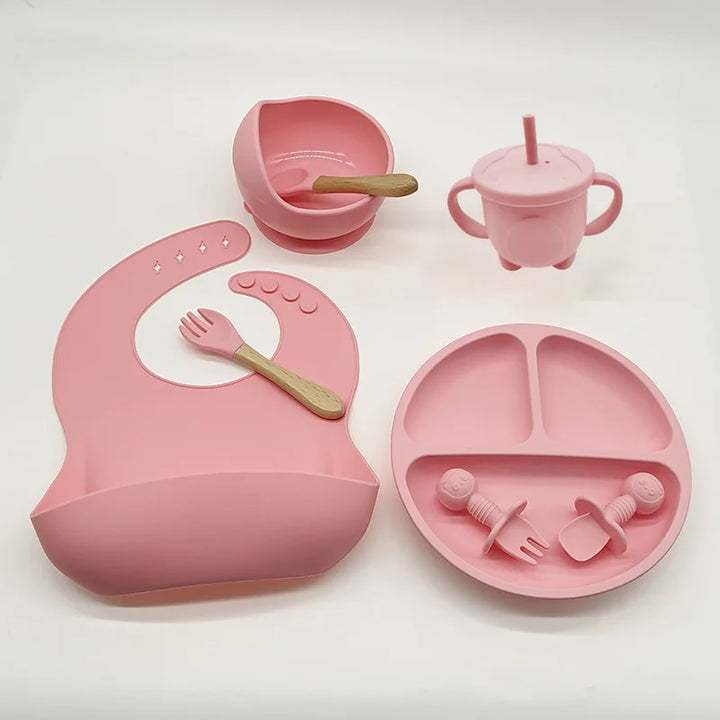TinyBites silicone baby feeding set, featuring a strong suction plate, bowl, spoon, and fork.