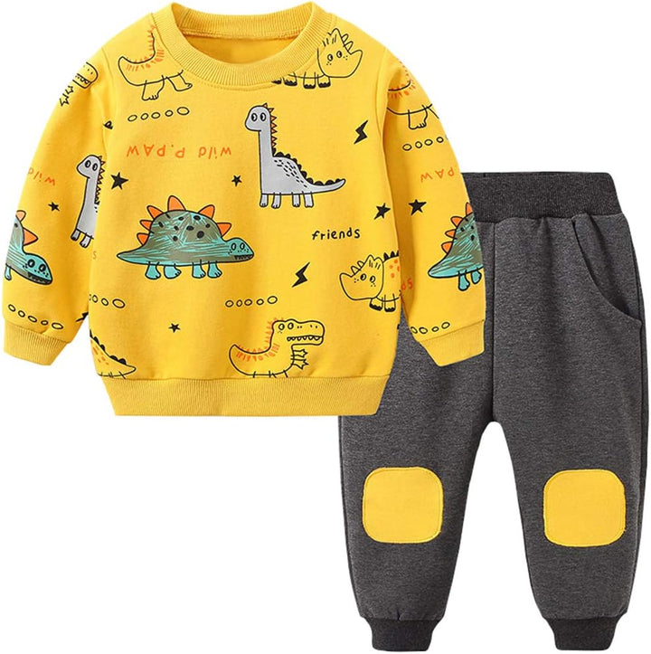 Toddler boy in blue dinosaur print short sleeve top and matching shorts set, perfect for summer play.