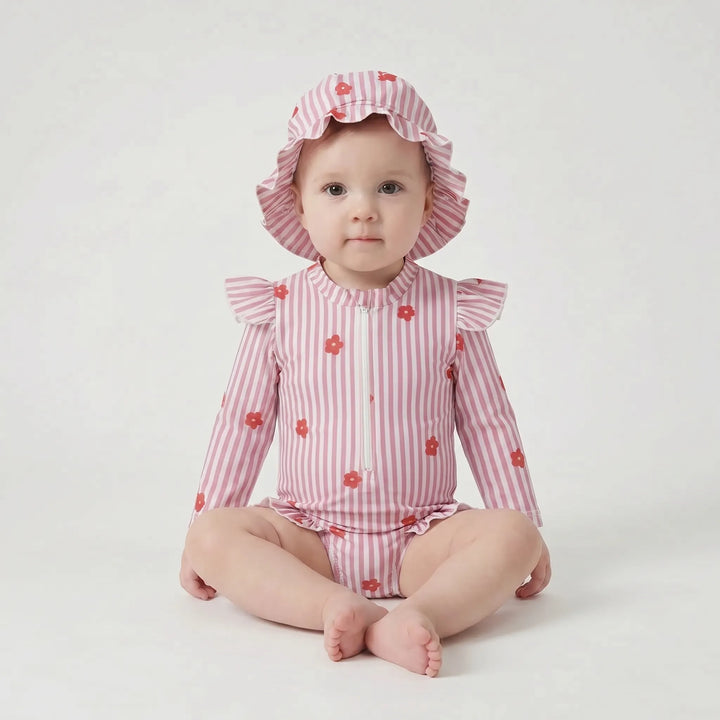 Fashionable toddler girl's long-sleeve rash guard swimsuit with sun hat for stylish UV protection.