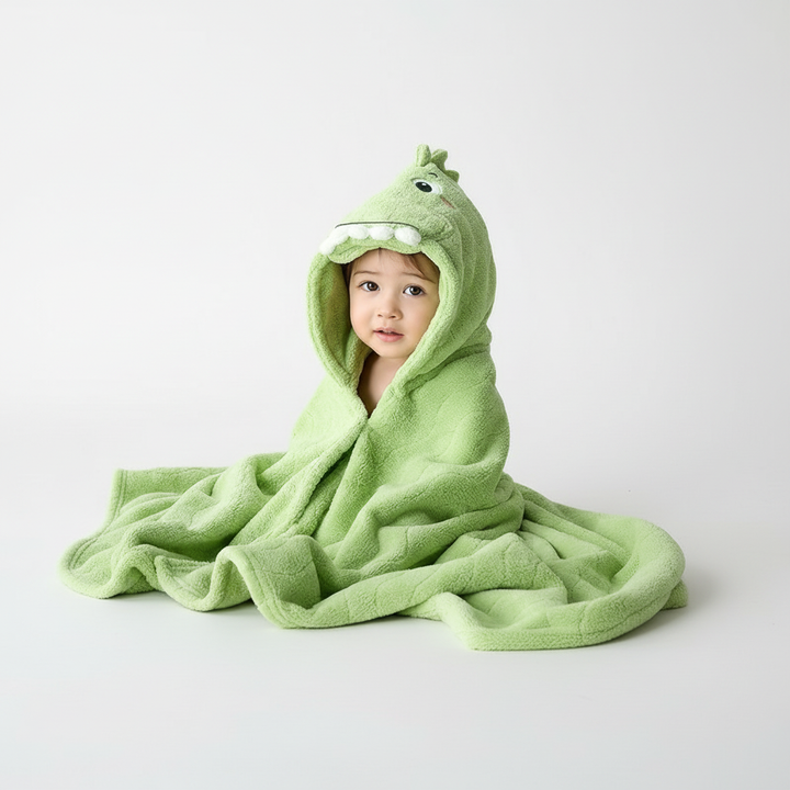 Close-up of a smiling toddler wearing a SnuggleDino hooded animal bathrobe after bath