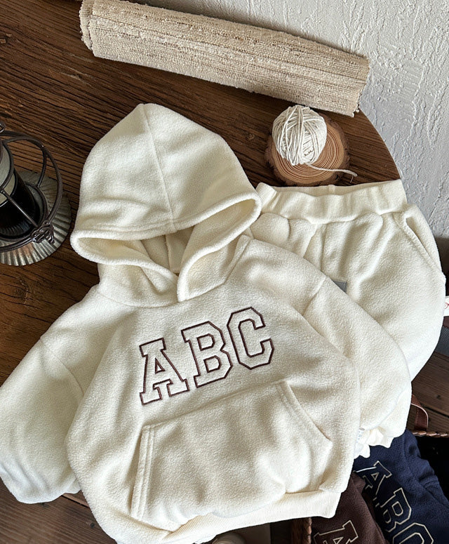 Children's winter clothing set with soft fleece lining, cotton hoodie and matching trousers for warmth.