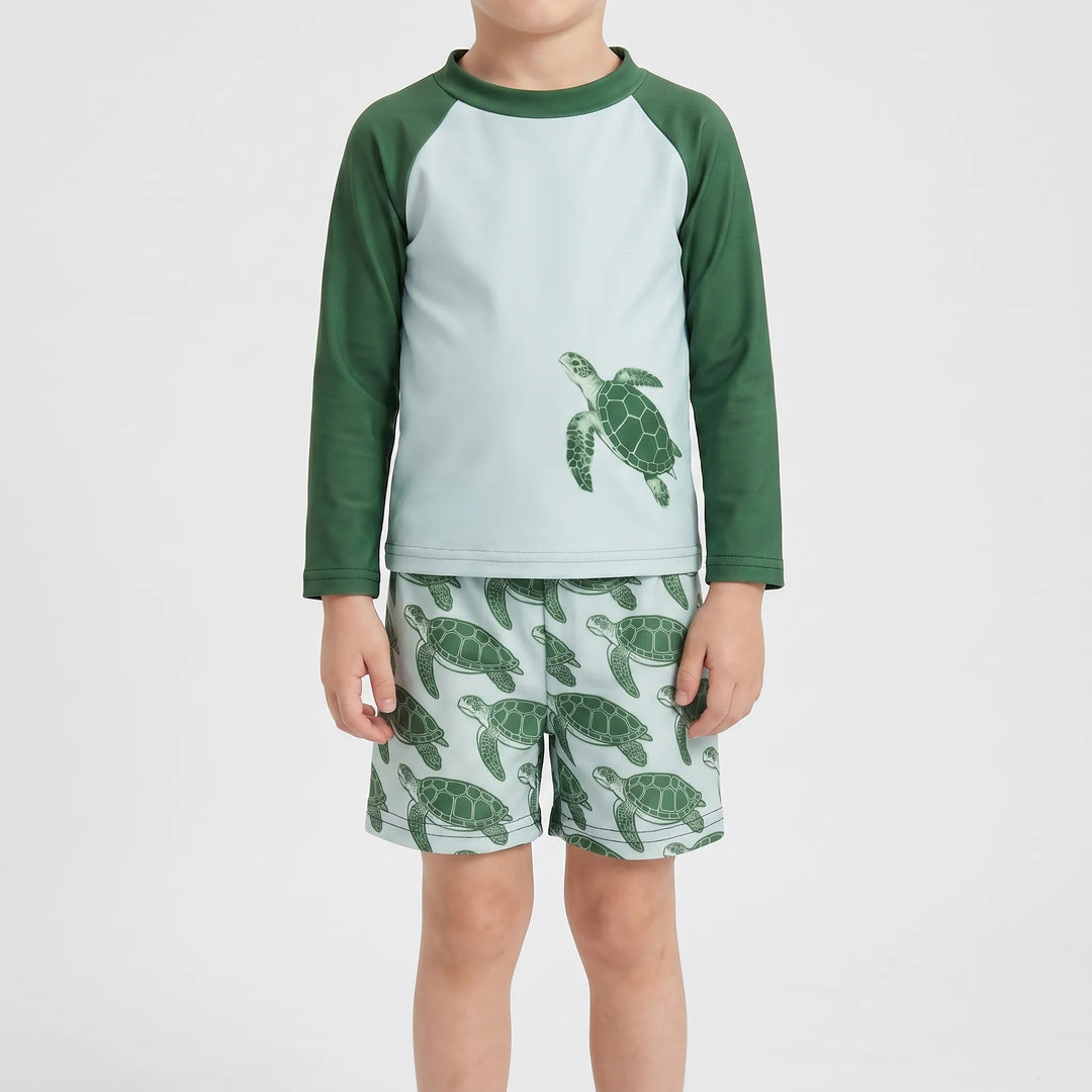 Unisex toddler long-sleeve rash guard set with tortoise print for sun protection at the beach.