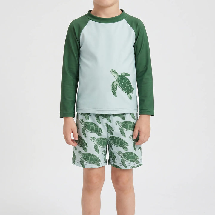 Unisex toddler long-sleeve rash guard set with tortoise print for sun protection at the beach.