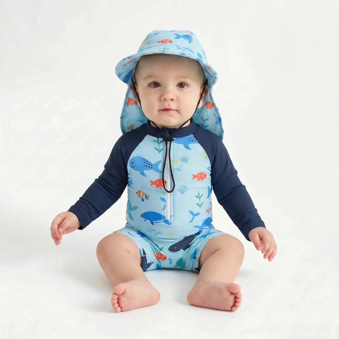 Detail shot: marine print long-sleeve toddler swim romper with matching sun hat, ideal for UV protection.