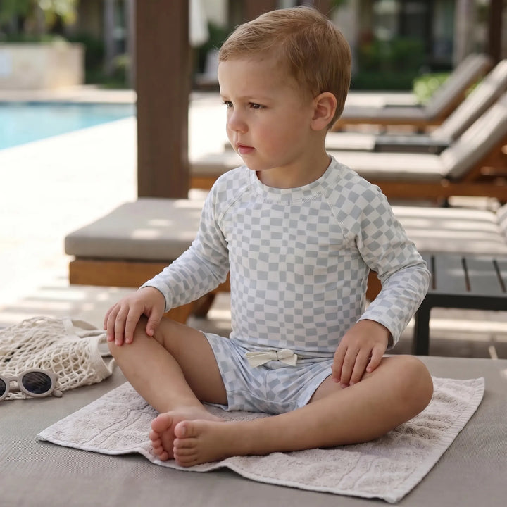Toddler's long-sleeve swimwear set for sun protection, perfect for beach and water play.