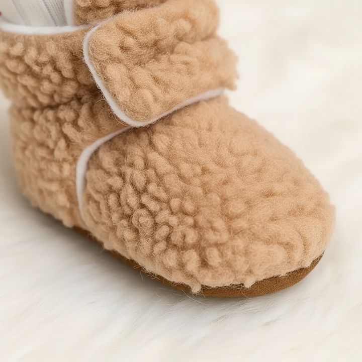 Pair of blue toddler SnuggleBoots slipper socks made from soft teddy fabric, ideal for indoor play.