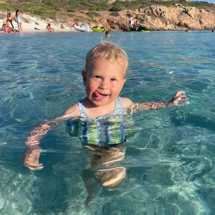Toddler swim vest with UV protection, blue, and built-in shorts for comfortable pool & beach fun.