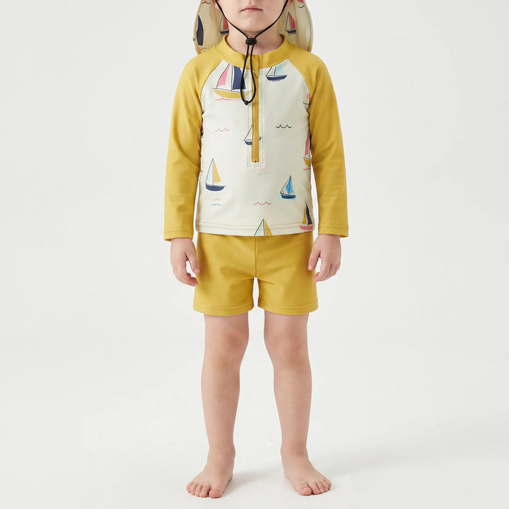 Comfortable toddler unisex long-sleeve swim set, including top, shorts & matching hat, perfect for pool or beach.