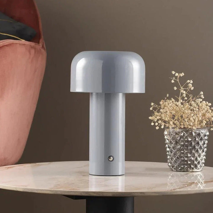 Portable LED nightstand lamp with touch control, providing warm ambient lighting.
