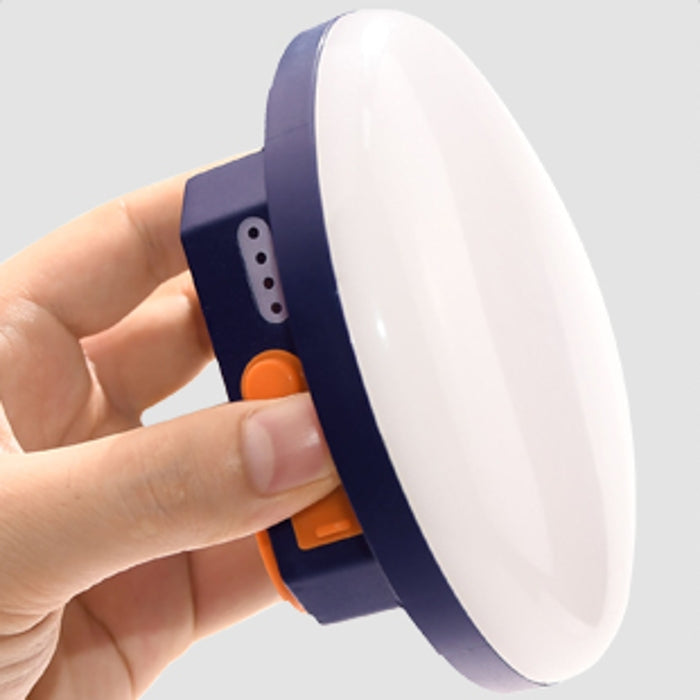 TrailCharge Multifunctional Outdoor Power Bank with LED light, warm glow, on a camping table.