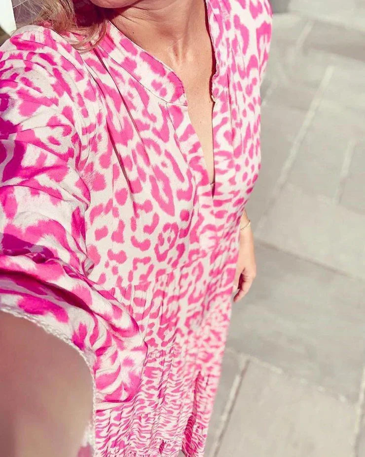 Chic women's pink leopard print maxi dress featuring a flattering V-neck and stylish bell sleeves. Perfect for events.