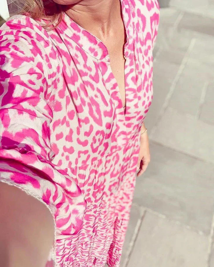 Chic women's pink leopard print maxi dress featuring a flattering V-neck and stylish bell sleeves. Perfect for events.
