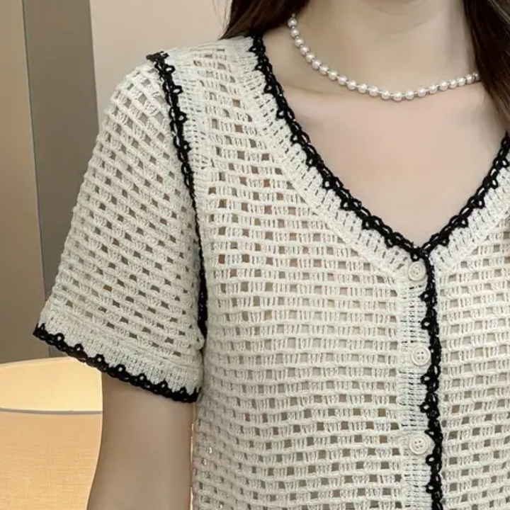 Versatile white openwork blouse for women, featuring elegant lace and a trendy design, ideal for casual and dressy looks.