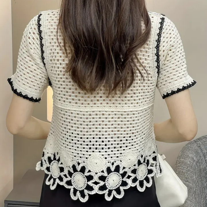 Fashionable white openwork blouse for women, a lightweight lace top for trendy spring and summer style. Casual elegance.