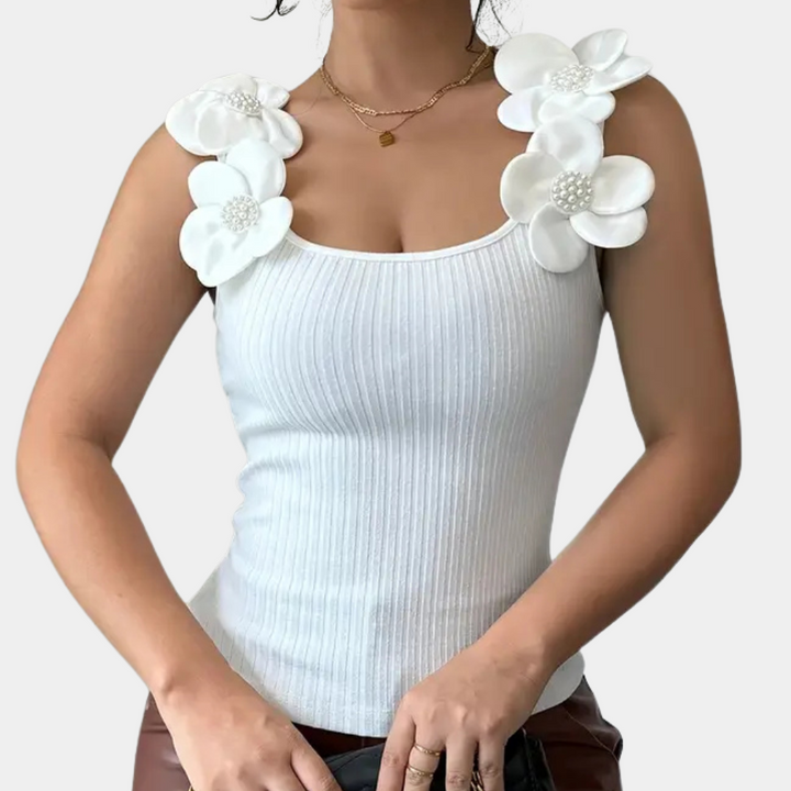 Elegant white sleeveless women's top with charming floral details. Perfect for spring fashion & brunch.