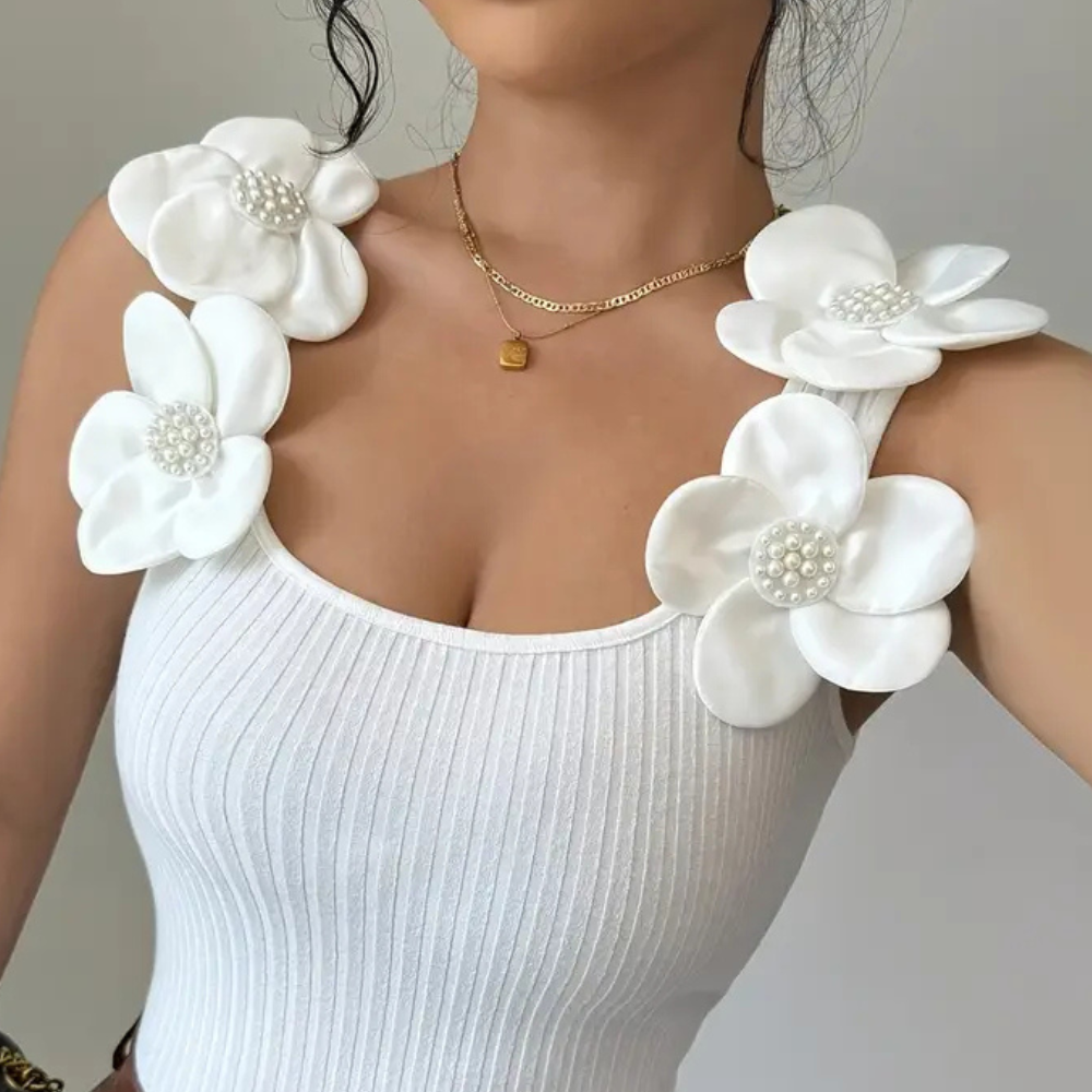 Women's white sleeveless top, featuring beautiful floral embroidery. Casual chic and elegant for any occasion.