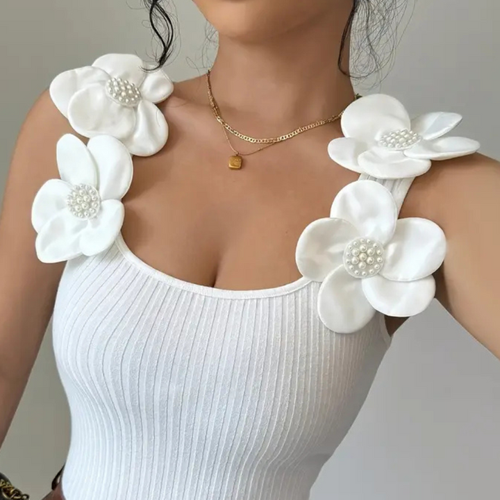 Women's white sleeveless top, featuring beautiful floral embroidery. Casual chic and elegant for any occasion.
