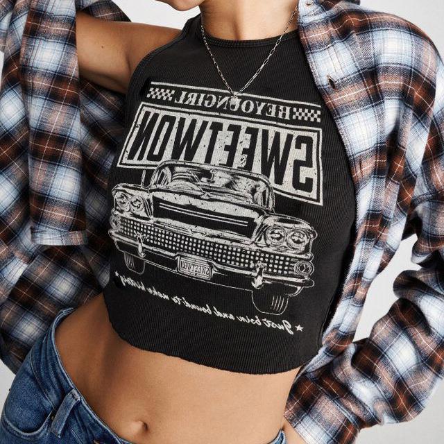 Stylish women's graphic crop top featuring a bold car print & comfortable round neck. Ideal for a trendy summer look.