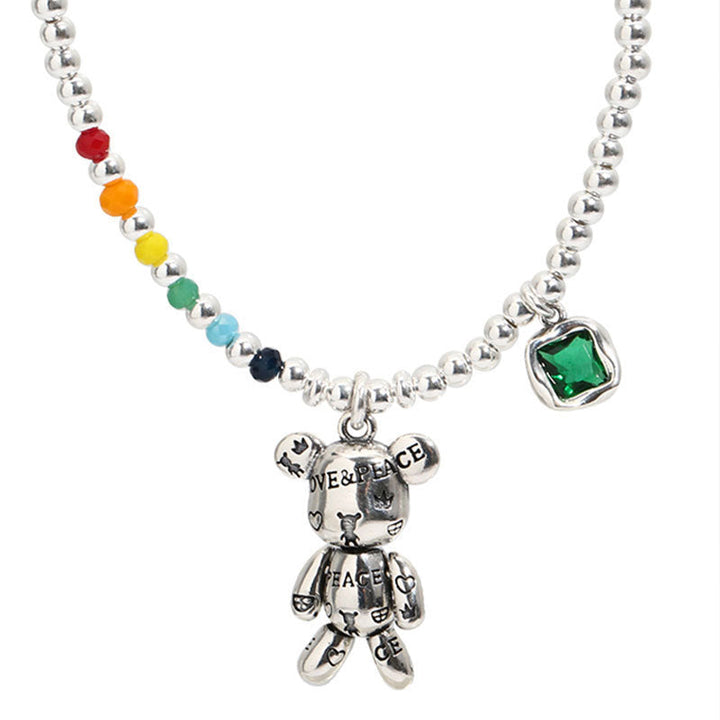Close-up of a women's trendy stainless steel necklace. Features a striking white gemstone on a delicate chain.