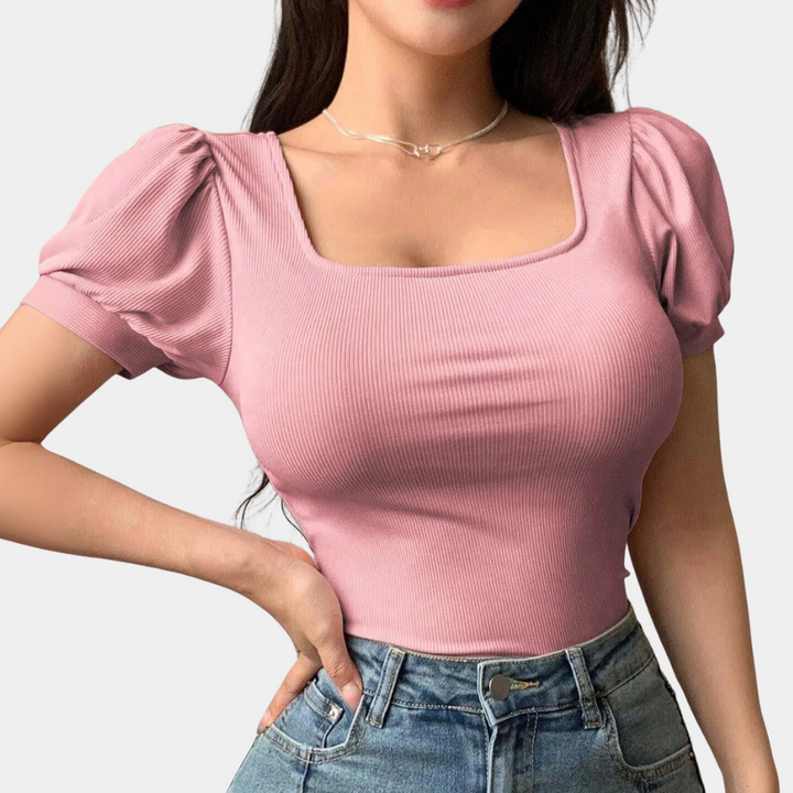 Stylish pink women's top featuring a square neck and puff sleeves, offering a casual chic and fashionable appeal.