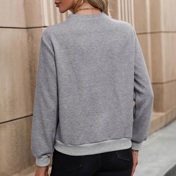 Chic women's button accent sweater, long sleeve, offering comfortable and stylish wear.