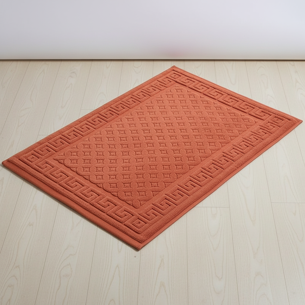 Close-up of the textured, absorbent cotton rectangular bath mat, part of a two-piece bathroom set