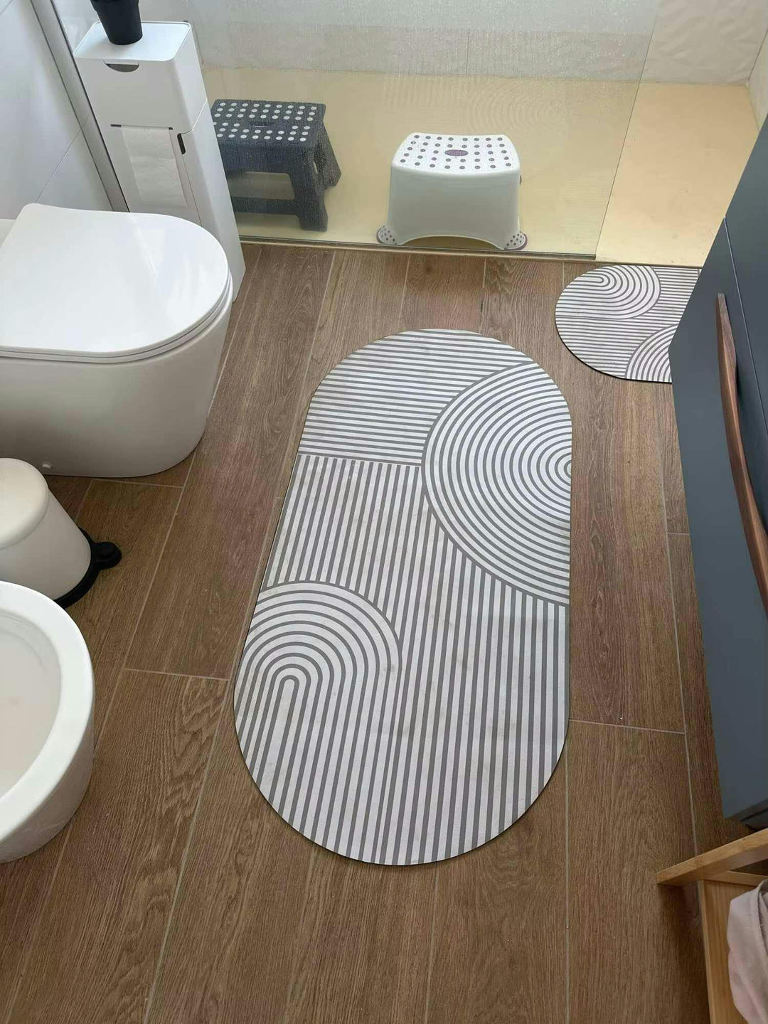 Absorbent non-slip bathroom or laundry room floor mat, quick-drying washable textile for wet areas.